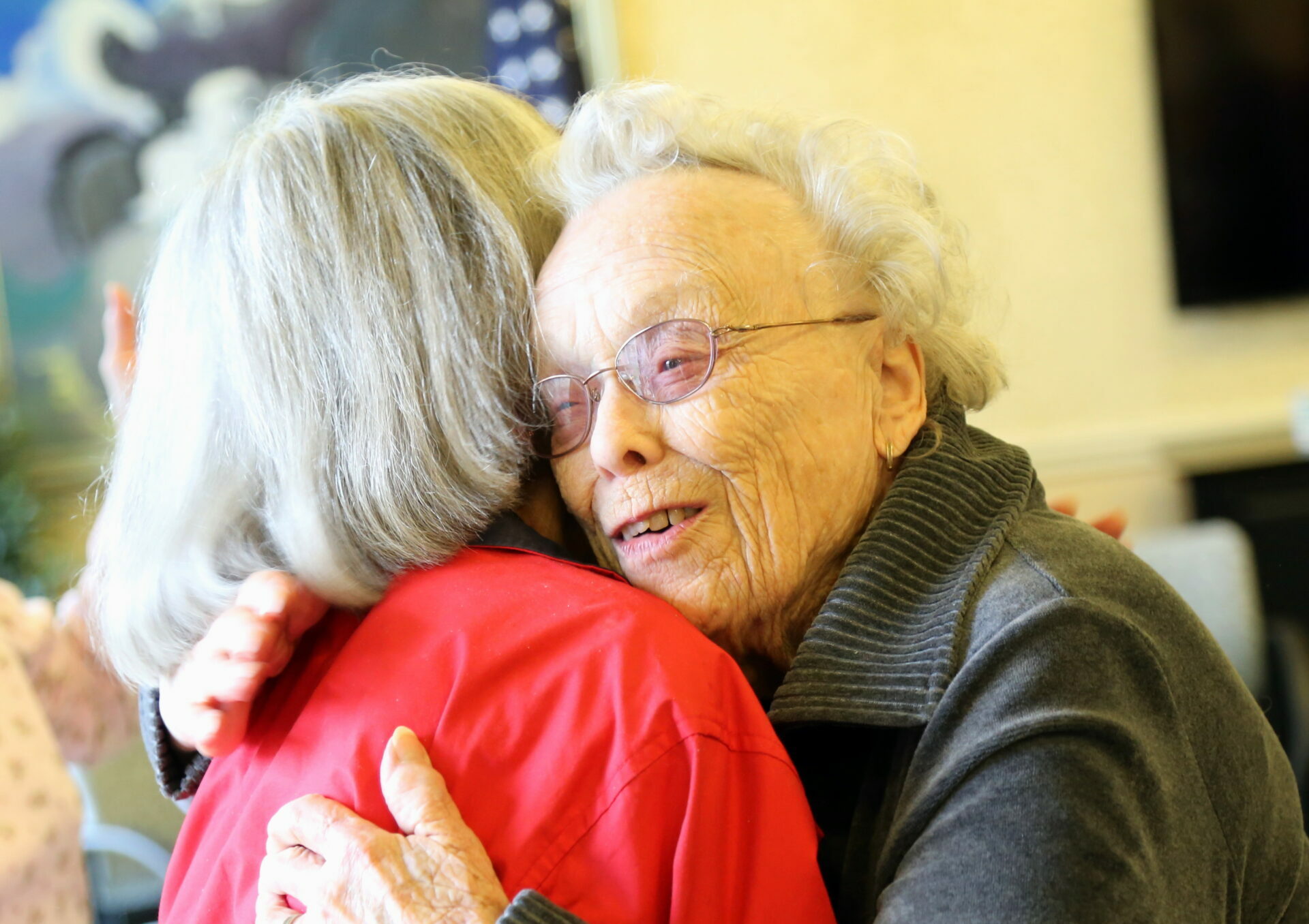 two seniors in a hug